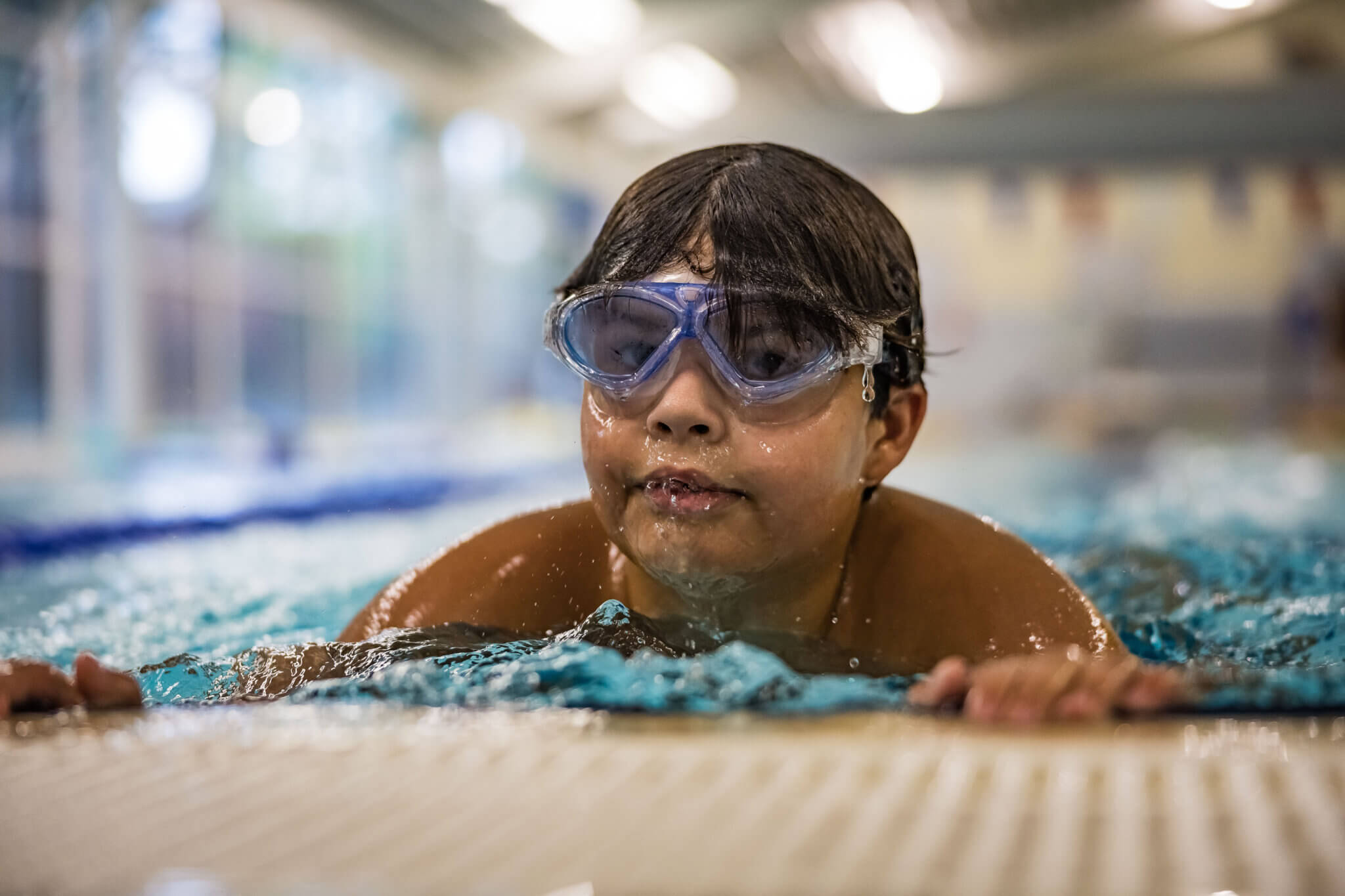 Child in water at pool edge