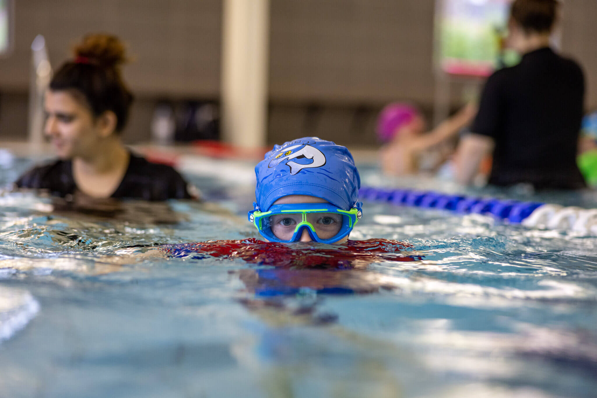 Swimmer with goggles about to go underwater
