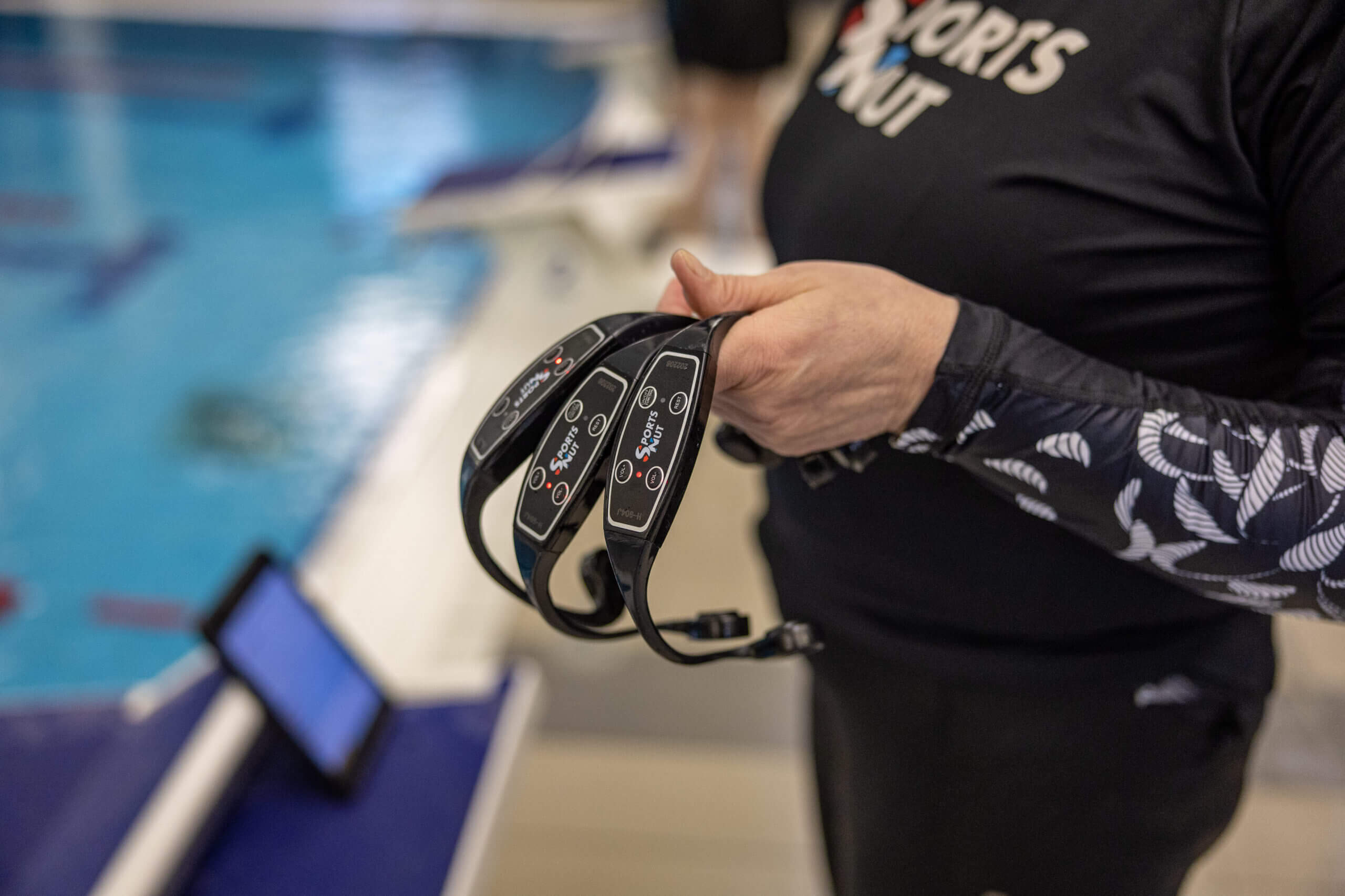 instructor holding bone conductor headset